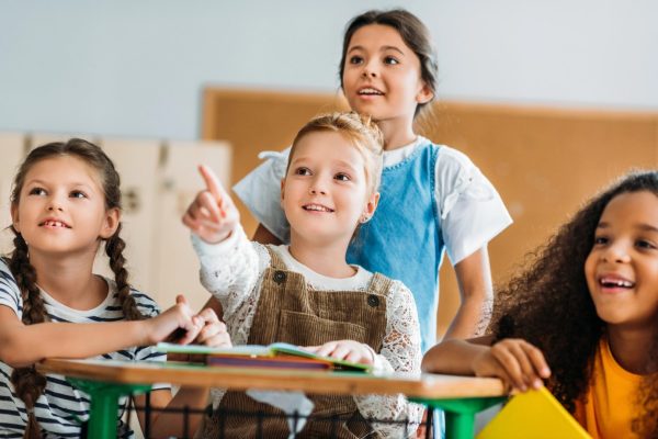 Excited students pointing to something off screen