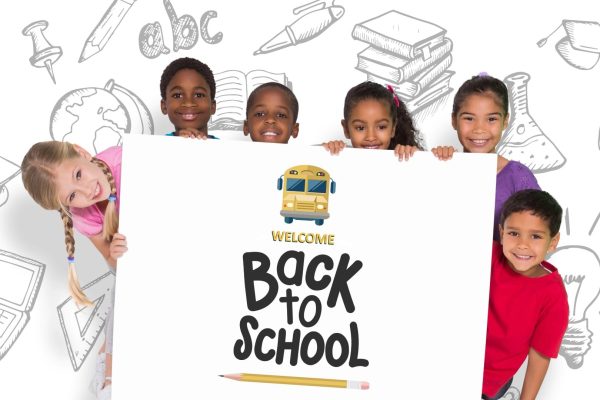 Smiling kids holding a back to school sign. Smiling kids holding a back to school sign.