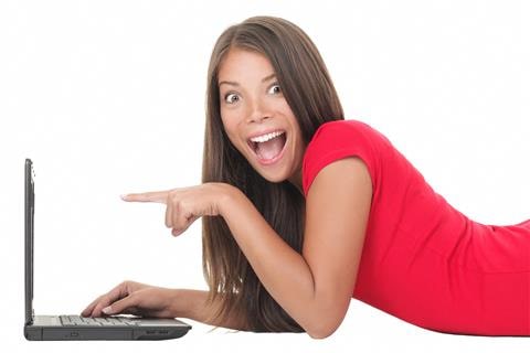 Websites/Online Resources - Image of a very happy woman pointing to her laptop.