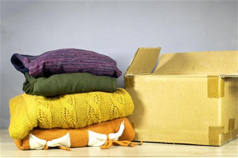 Food and Clothing - Image of folded clothes and a brown box.